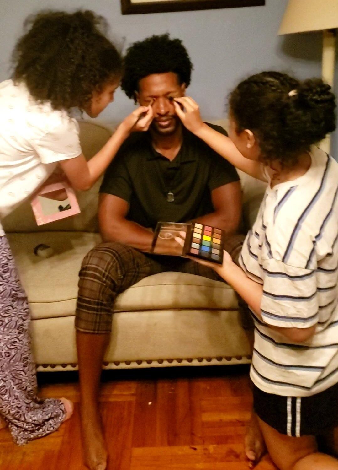 Me accepting my defeat and allowing family to put makeup on my face.