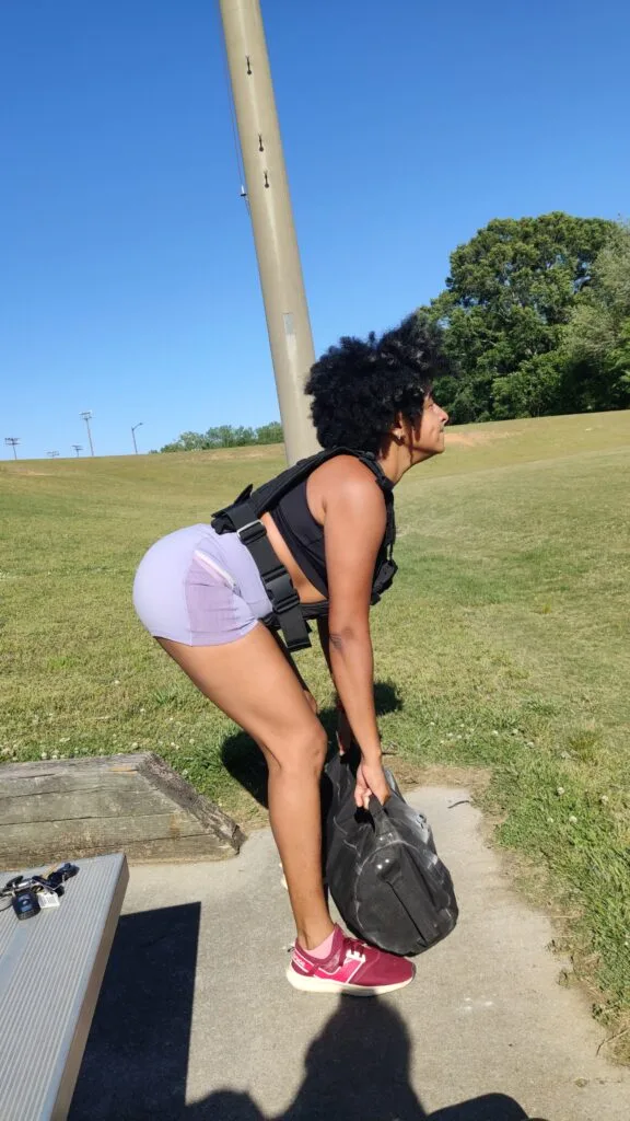 Sayu deadlifting with a sandbag