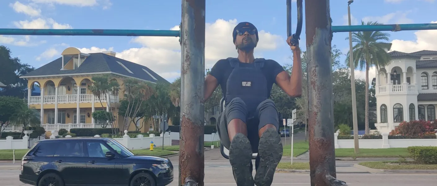 Doing pull ups at a calisthenics park