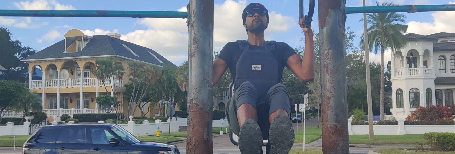 Doing pull ups at a calisthenics park